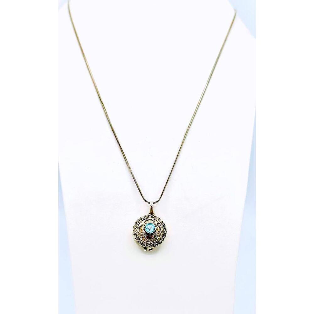 Vintage sterling silver chain with round ornate Bali design blue topaz locket